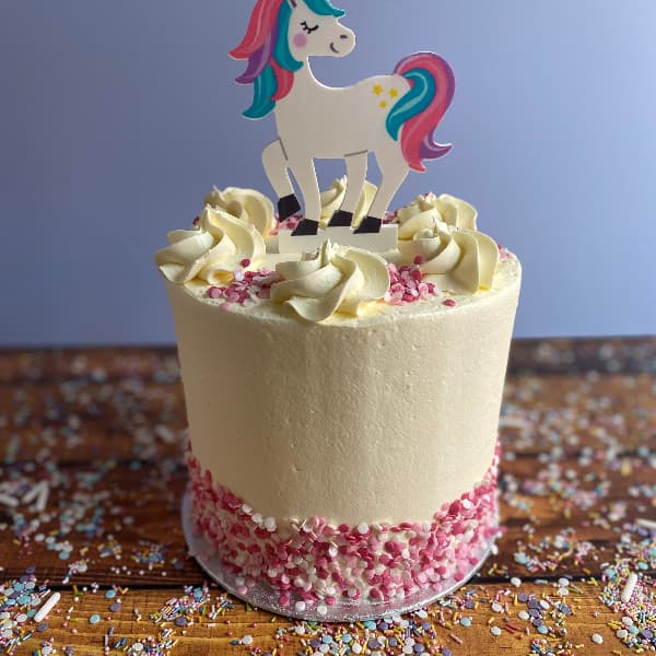 Tall Unicorn Buttercream Cake 2023 Tall Buttercream Cake with Unicorn Topper and Pink Sprinkles